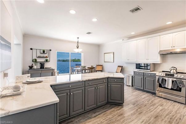 Dining room, Interior, Kitchen, Pendant Lights, Recessed Lighting, Stainless Steel Appliances, Water, Wood Texture Flooring
