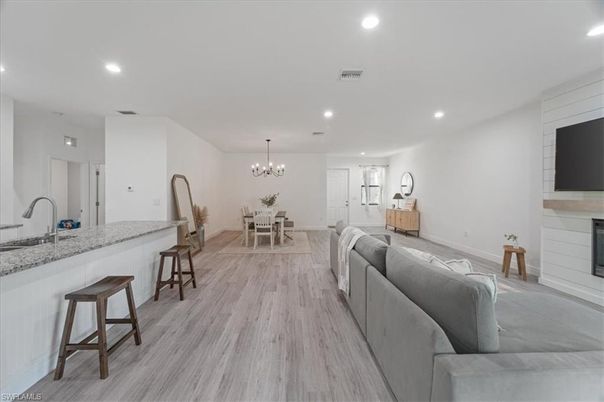 Chandelier, Dining room, Fireplace, Interior, Kitchen, Living room, Recessed Lighting, Wood Texture Flooring