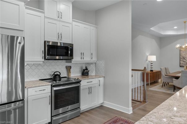 Chandelier, Dining room, Interior, Kitchen, Recessed Lighting, Stainless Steel Appliances, Wood Texture Flooring