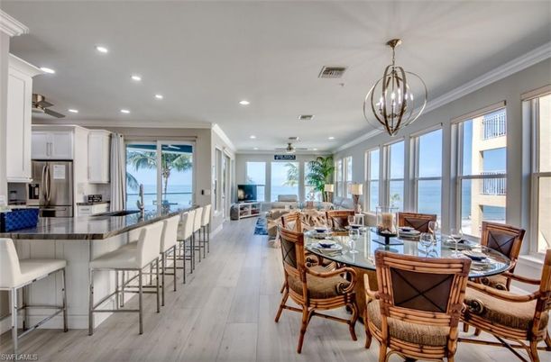Chandelier, Dining room, Interior, Kitchen, Living room, Pendant Lights, Recessed Lighting, Stainless Steel Appliances, Water, Wood Texture Flooring