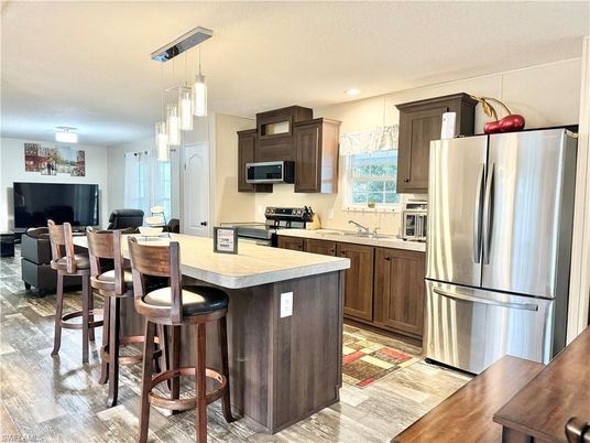 Dining room, Interior, Kitchen, Pendant Lights, Recessed Lighting, Stainless Steel Appliances, Wood Texture Flooring