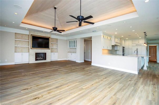 Empty room, Fireplace, Interior, Kitchen, Pendant Lights, Recessed Lighting, Wood Texture Flooring
