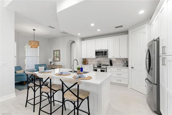 Chandelier, Dining room, Interior, Kitchen, Pendant Lights, Recessed Lighting, Stainless Steel Appliances, Wood Texture Flooring