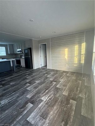 Empty room, Interior, Kitchen, Recessed Lighting, Stainless Steel Appliances, Wood Texture Flooring