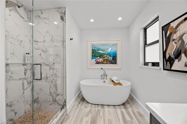 Bathroom, Free Standing Baths, Glass Shower, Interior, Marble Walls, Recessed Lighting, Wood Texture Flooring