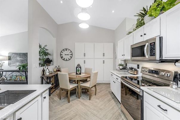 Dining room, Interior, Kitchen, Pendant Lights, Recessed Lighting, Stainless Steel Appliances, Wood Texture Flooring