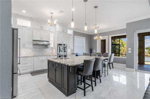 Chandelier, Dining room, Interior, Kitchen, Marble, Pendant Lights, Recessed Lighting, Stainless Steel Appliances
