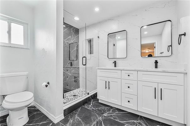 Bathroom, Dual Sink Vanities, Glass Shower, Interior, Marble, Marble Walls, Recessed Lighting