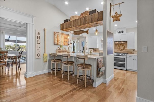 Dining room, Interior, Kitchen, Pendant Lights, Recessed Lighting, Stainless Steel Appliances, Wood Texture Flooring