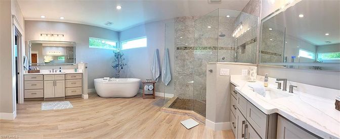Bathroom, Dual Sink Vanities, Free Standing Baths, Glass Shower, Interior, Marble Walls, Recessed Lighting, Wood Texture Flooring