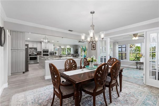 Chandelier, Dining room, Interior, Kitchen, Pendant Lights, Recessed Lighting, Stainless Steel Appliances, Wood Texture Flooring