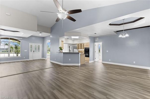 Empty room, Interior, Kitchen, Pendant Lights, Recessed Lighting, Stainless Steel Appliances, Wood Texture Flooring