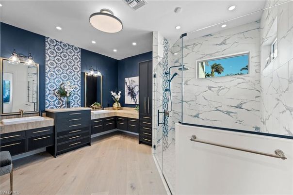 Bathroom, Dual Sink Vanities, Interior, Marble Walls, Recessed Lighting, Wood Texture Flooring