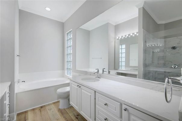 Bathroom, Dual Sink Vanities, Glass Shower, Interior, Marble Walls, Recessed Lighting, Wood Texture Flooring