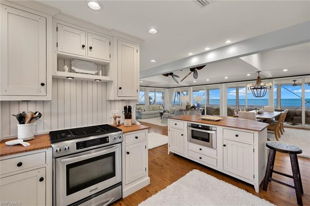 Chandelier, Dining room, Interior, Kitchen, Living room, Recessed Lighting, Stainless Steel Appliances, Water, Wood Texture Flooring