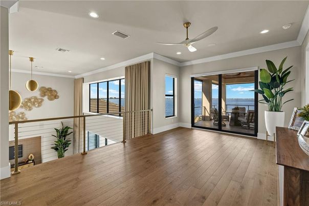Empty room, Fireplace, Interior, Pendant Lights, Recessed Lighting, Water, Wood Texture Flooring