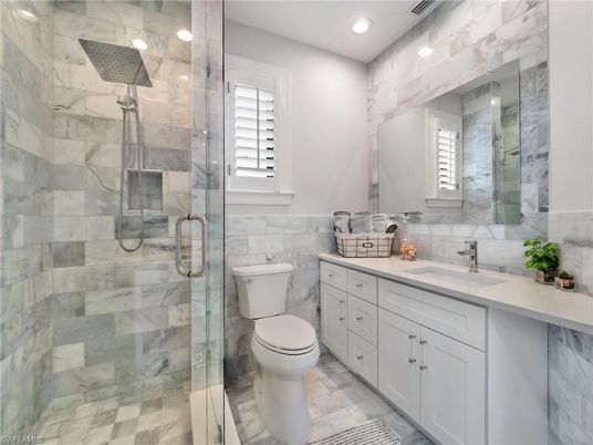 Bathroom, Dual Sink Vanities, Glass Shower, Interior, Marble Walls, Recessed Lighting