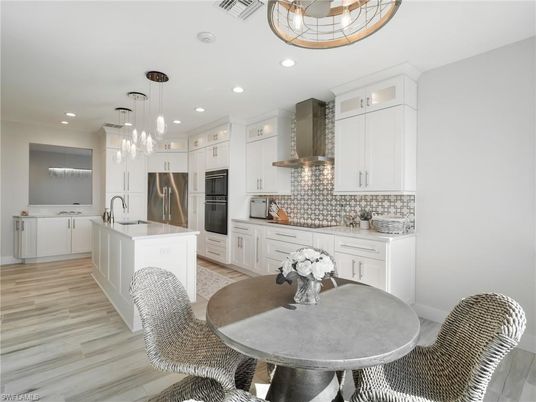 Dining room, Interior, Kitchen, Pendant Lights, Recessed Lighting, Stainless Steel Appliances, Wood Texture Flooring