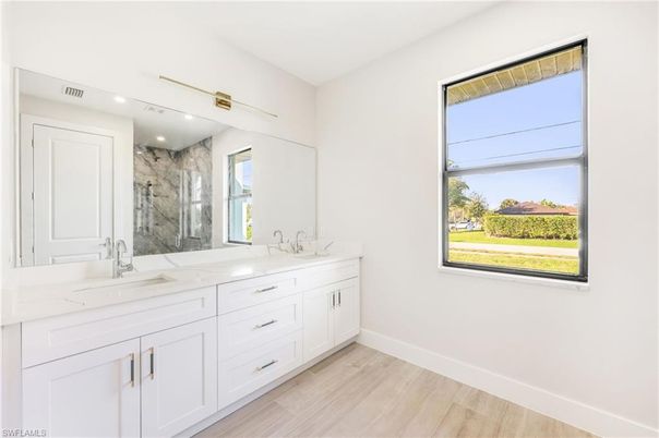 Bathroom, Dual Sink Vanities, Interior, Marble Walls, Recessed Lighting, Wood Texture Flooring