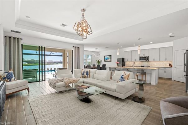 Chandelier, Dining room, Interior, Kitchen, Living room, Pendant Lights, Recessed Lighting, Stainless Steel Appliances, Wood Texture Flooring