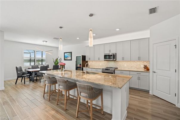 Dining room, Interior, Kitchen, Pendant Lights, Recessed Lighting, Stainless Steel Appliances, Wood Texture Flooring