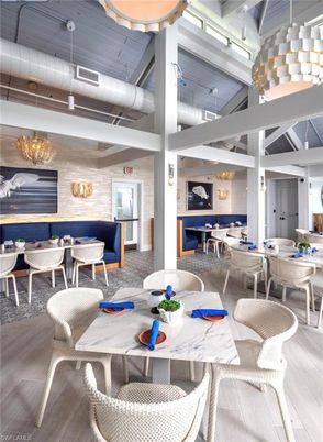 Chandelier, Dining room, Fireplace, Interior, Living room, Pendant Lights, Stone Walls, Wood Texture Flooring