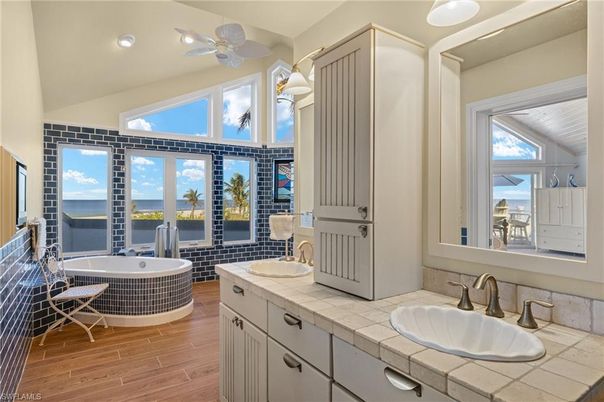 Bathroom, Dual Sink Vanities, Interior, Recessed Lighting, Tile Countertops, Water, Wood Texture Flooring