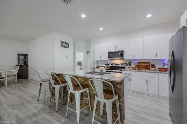 Dining room, Interior, Kitchen, Recessed Lighting, Stainless Steel Appliances, Wood Texture Flooring