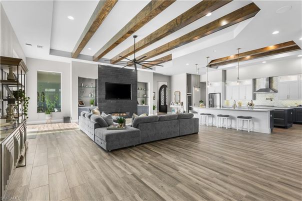 Fireplace, Interior, Kitchen, Living room, Pendant Lights, Recessed Lighting, Stainless Steel Appliances, Stone Walls, Wooden Beams, Wood Texture Flooring
