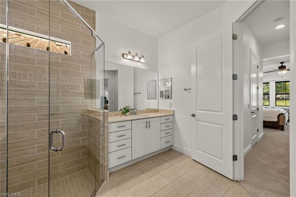 Bathroom, Dual Sink Vanities, Glass Shower, Interior, Recessed Lighting, Stone Walls, Wood Texture Flooring