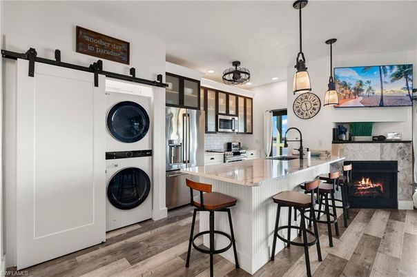 Fireplace, Interior, Kitchen, Pendant Lights, Recessed Lighting, Stainless Steel Appliances, Washer, Wood Texture Flooring