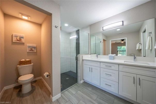 Bathroom, Dual Sink Vanities, Glass Shower, Interior, Recessed Lighting, Wood Texture Flooring