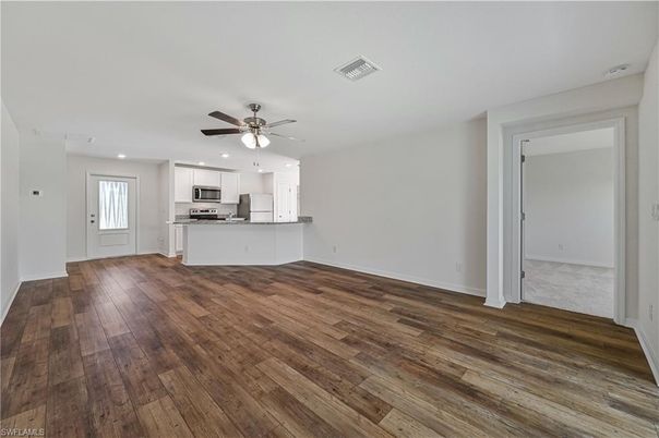 Empty room, Interior, Kitchen, Recessed Lighting, Stainless Steel Appliances, Wood Texture Flooring