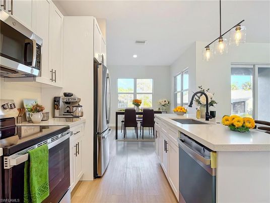 Dining room, Interior, Kitchen, Pendant Lights, Recessed Lighting, Stainless Steel Appliances, Wood Texture Flooring