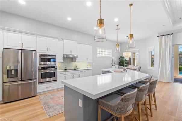Dining room, Interior, Kitchen, Pendant Lights, Recessed Lighting, Stainless Steel Appliances, Wood Texture Flooring