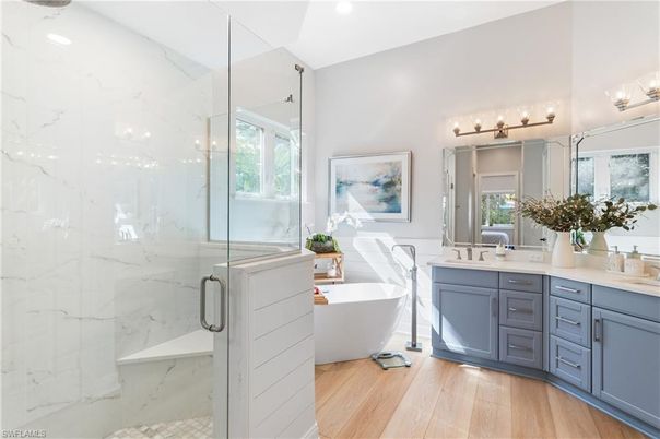 Bathroom, Free Standing Baths, Glass Shower, Interior, Marble Walls, Recessed Lighting, Wood Texture Flooring