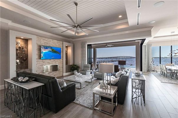 Dining room, Fireplace, Interior, Living room, Recessed Lighting, Stone Walls, Water, Wood Texture Flooring