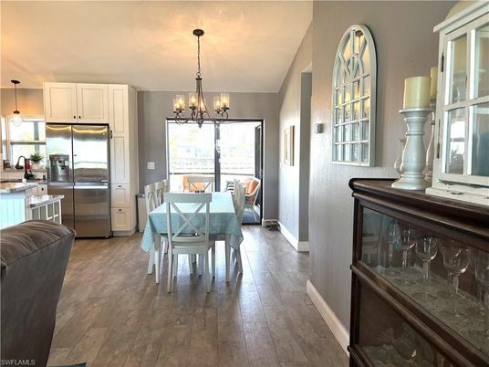 Chandelier, Dining room, Interior, Kitchen, Pendant Lights, Stainless Steel Appliances, Wood Texture Flooring
