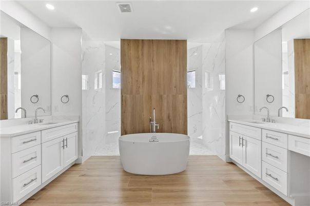Bathroom, Dual Sink Vanities, Free Standing Baths, Interior, Marble Walls, Recessed Lighting, Wood Texture Flooring