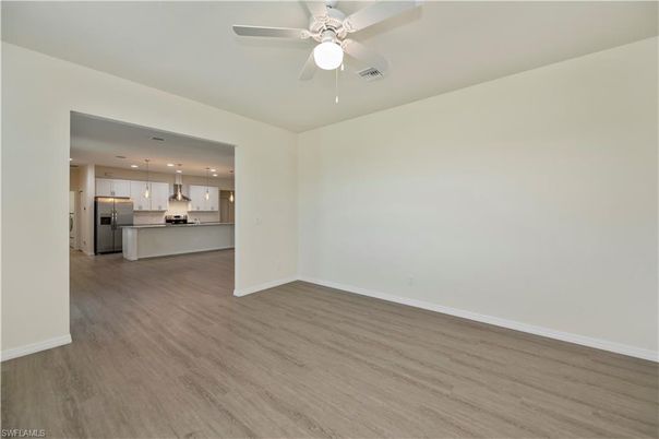 Empty room, Interior, Kitchen, Pendant Lights, Recessed Lighting, Stainless Steel Appliances, Wood Texture Flooring