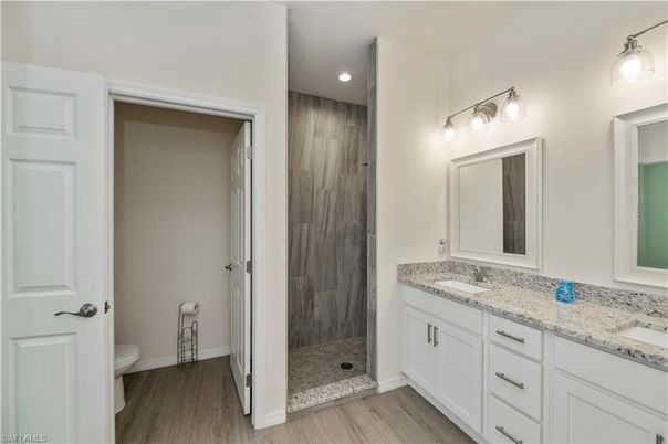 Bathroom, Dual Sink Vanities, Glass Shower, Interior, Recessed Lighting, Wood Texture Flooring