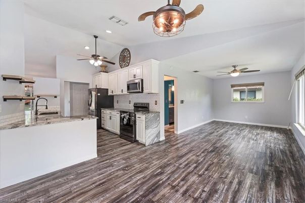 Empty room, Interior, Kitchen, Recessed Lighting, Stainless Steel Appliances, Wood Texture Flooring