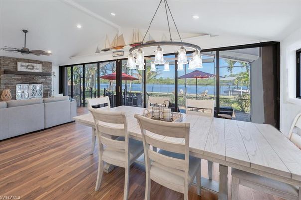 Dining room, Fireplace, Interior, Living room, Pendant Lights, Recessed Lighting, Stone Walls, Water, Wood Texture Flooring