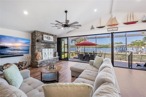 Fireplace, Interior, Living room, Recessed Lighting, Stone Walls, Water, Wood Texture Flooring