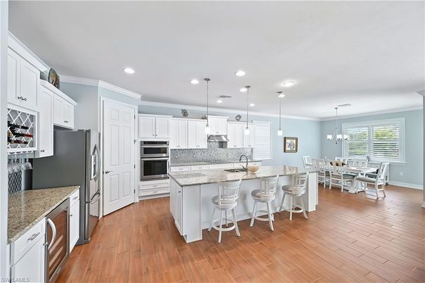 Chandelier, Dining room, Interior, Kitchen, Pendant Lights, Recessed Lighting, Stainless Steel Appliances, Wood Texture Flooring