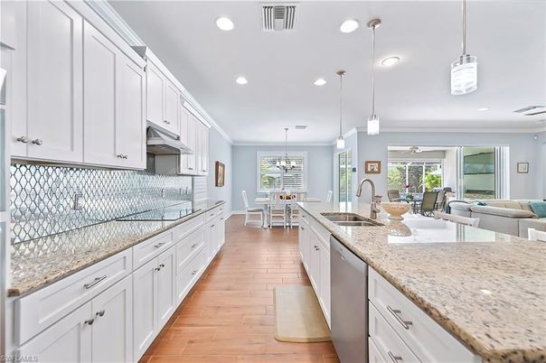 Chandelier, Dining room, Interior, Kitchen, Living room, Pendant Lights, Recessed Lighting, Stainless Steel Appliances, Wood Texture Flooring