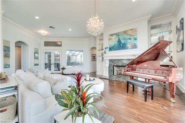 Chandelier, Fireplace, Interior, Living room, Piano, Recessed Lighting, Wood Texture Flooring