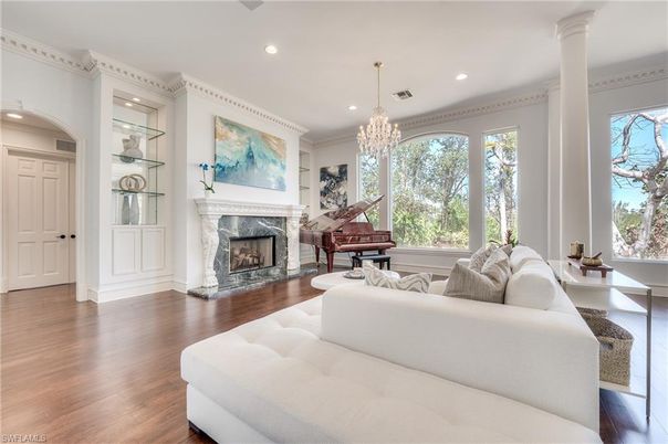 Chandelier, Fireplace, Interior, Living room, Piano, Recessed Lighting, Wood Texture Flooring