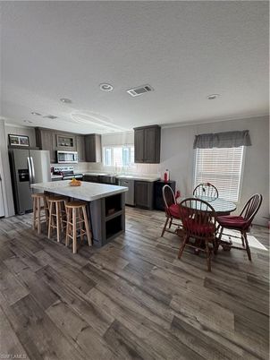 Dining room, Interior, Kitchen, Recessed Lighting, Stainless Steel Appliances, Wood Texture Flooring