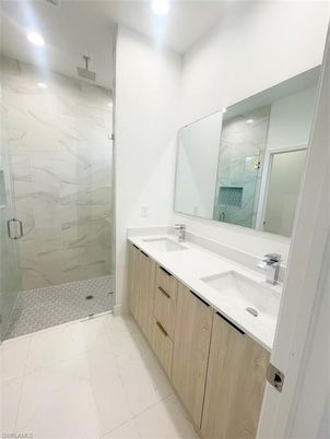 Bathroom, Dual Sink Vanities, Glass Shower, Interior, Marble Walls, Recessed Lighting